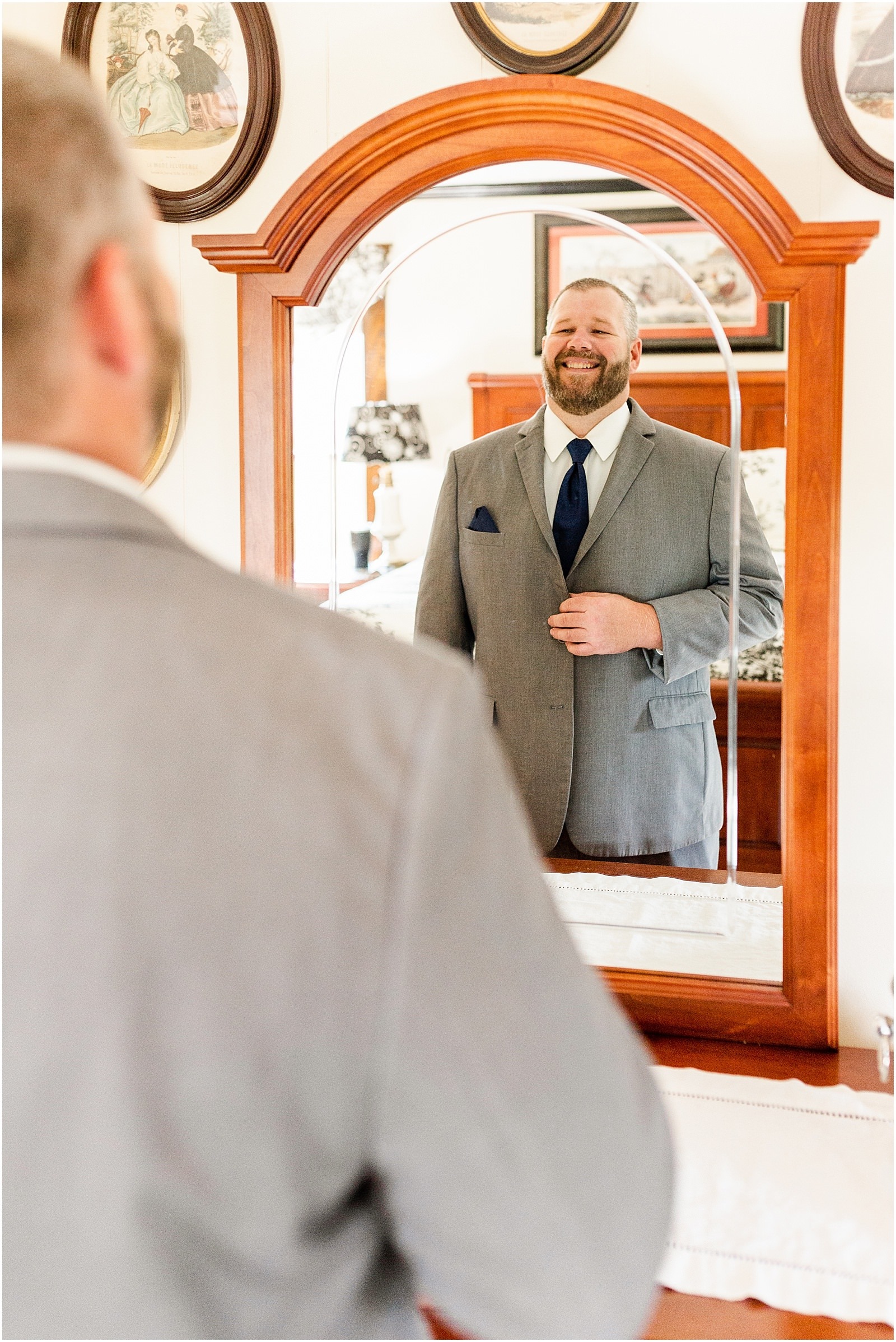 groom smiling in the mirror