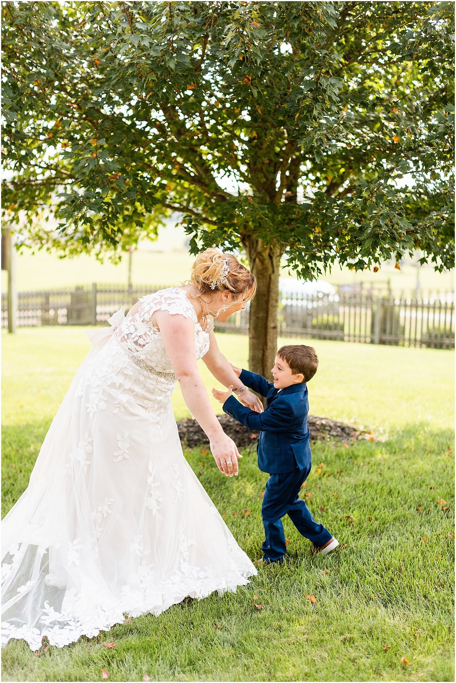 bride smiling and hugging young boy