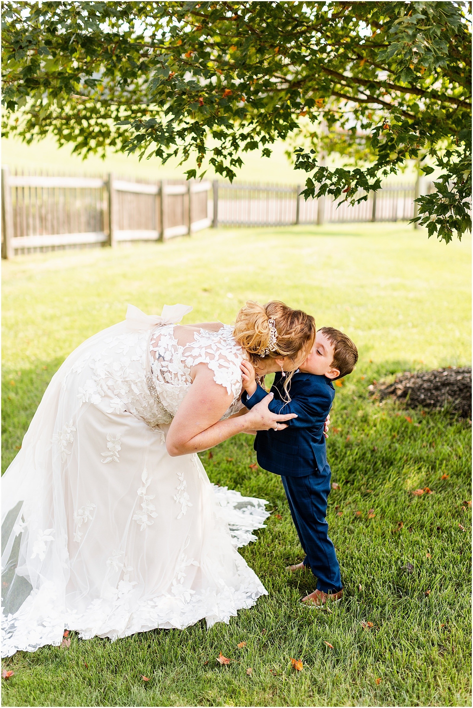 bride kissing her young son
