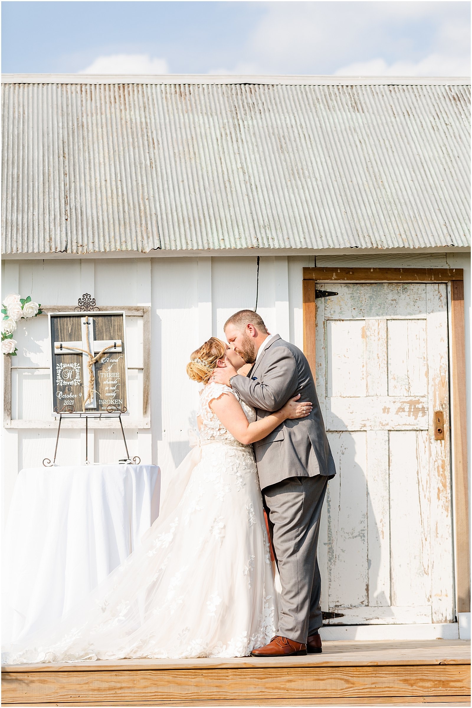 bride and groom's first kiss in outdoor wedding ceremony