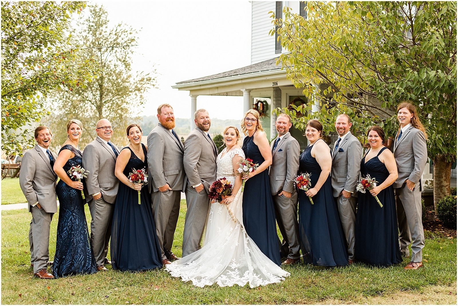 bride and groom with wedding party at farmhouse venue