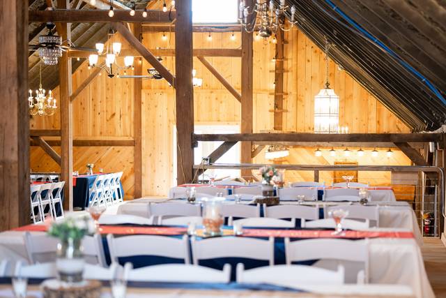 wedding reception tables in lofted barn venue